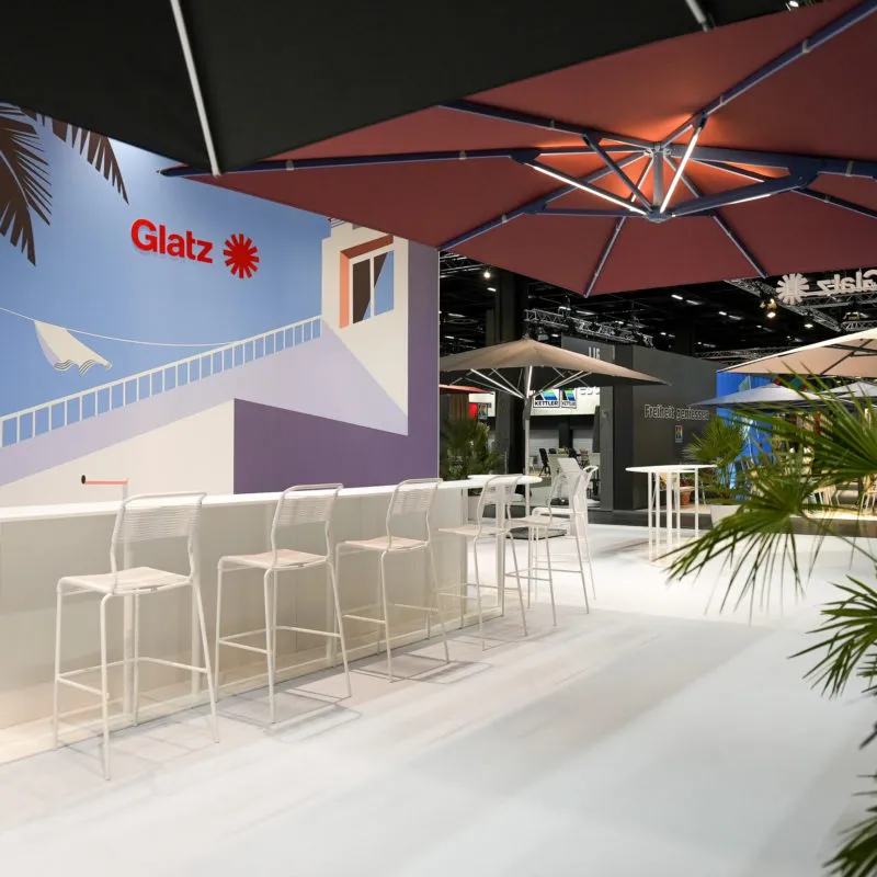 Glatz exhibition stand with custom printed wall graphics and parasol display area