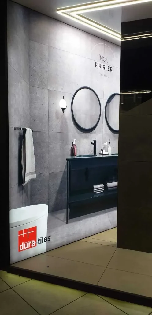Large-format illuminated bathroom wall graphic installed at a tile showroom