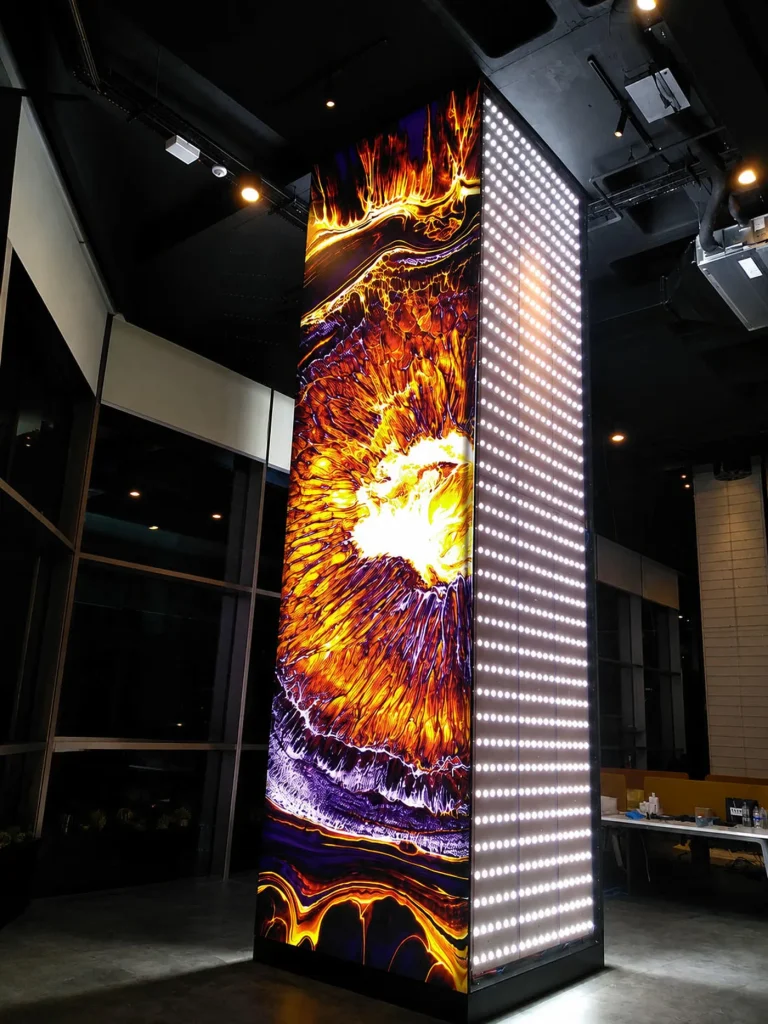 Large-scale illuminated column showing LED backlighting and finished graphic panel
